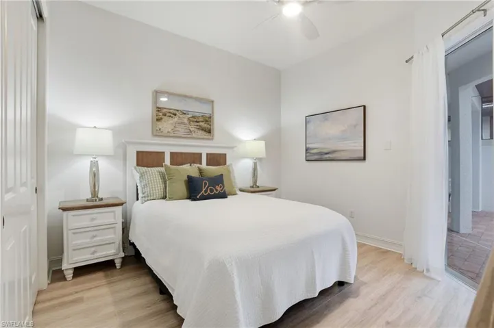 Bedroom featuring light wood finished floors, a ceiling fan, and a closet