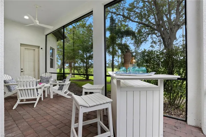 Sunroom / solarium with a patio and a ceiling fan