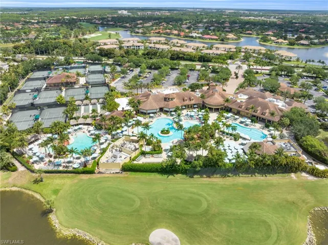 Aerial view of property and surrounding area featuring a large body of water and nearby suburban area