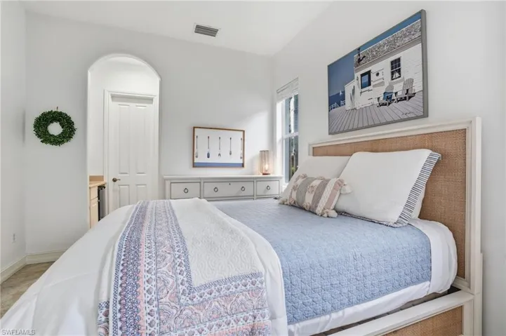 Bedroom with baseboards and light carpet