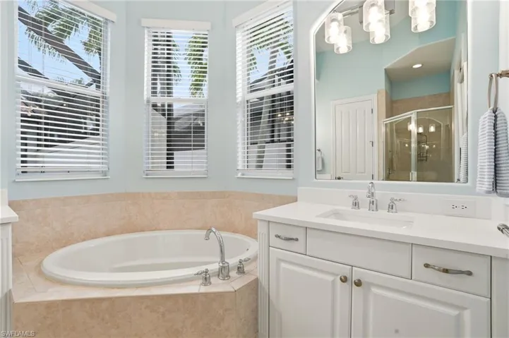 Bathroom with vanity, a shower stall, and a bath