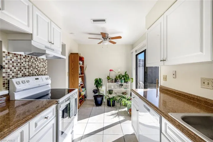 Unit #1 Kitchen and dining area with sliders to back patio.