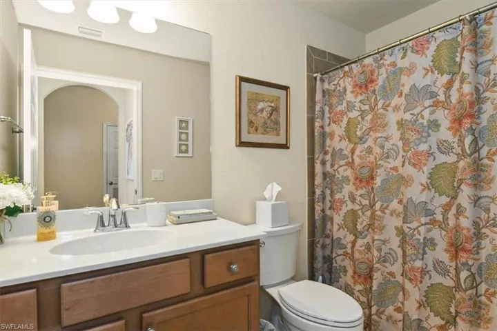 Full bath with vanity and curtained shower