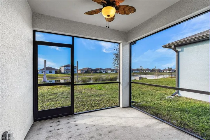 Large screened lanai  featuring a ceiling fan, and serene water view
