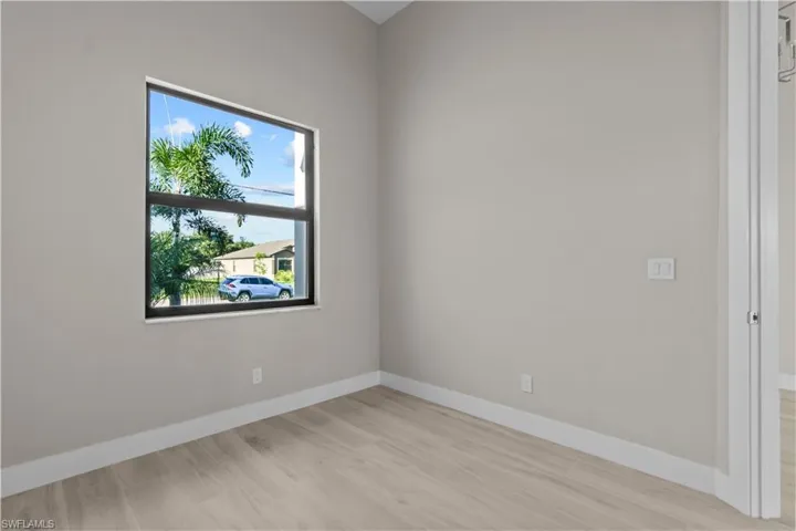 Empty room with light hardwood / wood-style flooring