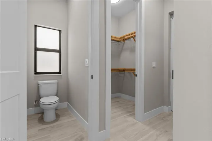 Bathroom featuring hardwood / wood-style flooring and toilet