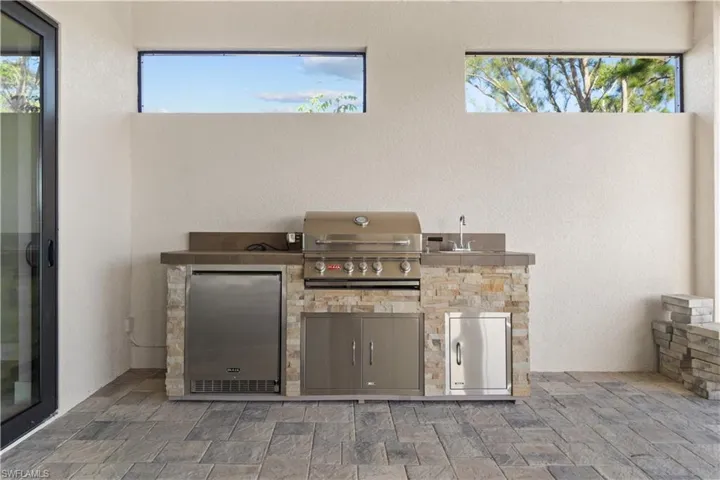 View of patio with sink, an outdoor kitchen, and area for grilling