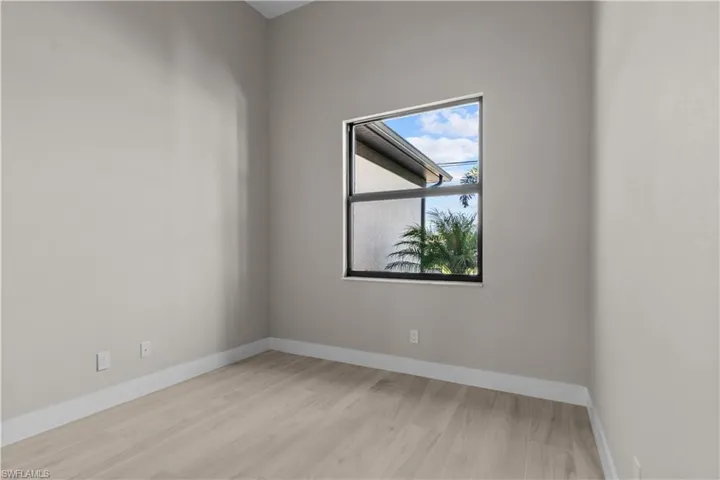 Empty room with light hardwood / wood-style flooring