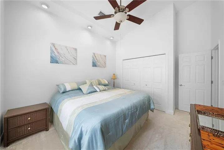 Vaulted ceilings, recessed lighting, ceiling fan, and multi-panel interior closet doors
