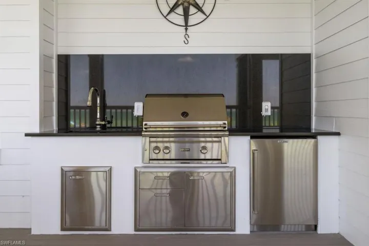 View of patio featuring area for grilling and a sink