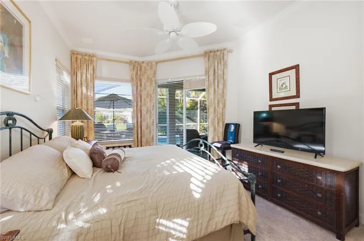Bedroom with crown molding, light colored carpet, ceiling fan, and access to exterior