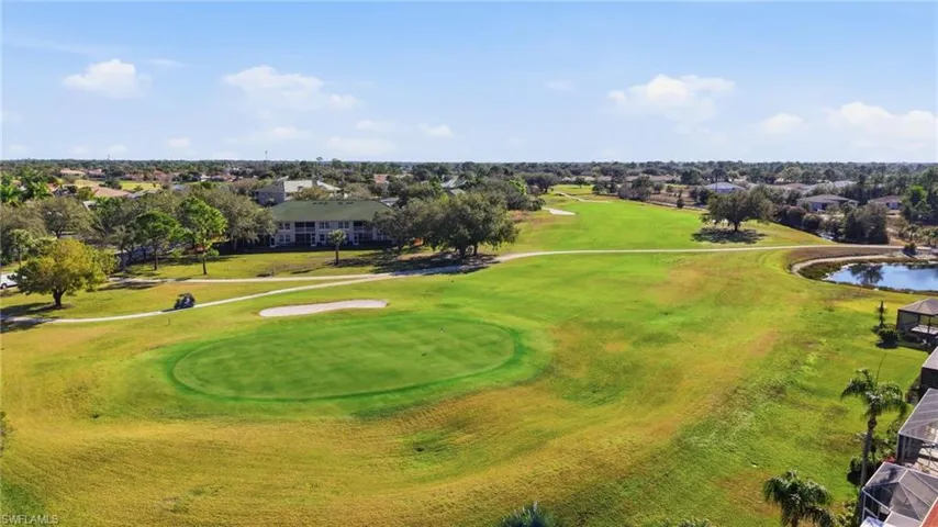 Amenities:Aerial perspective of suburban area featuring a golf course and a large body of water