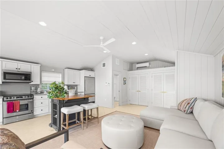Boathouse is reimagined as guest cottage with vaulted ceiling, sofa bed, kitchen, washer/dryer, and bathroom