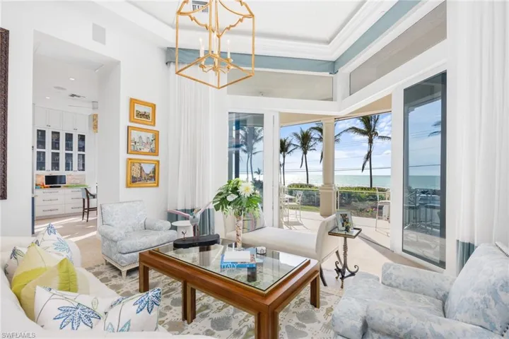 Living room located on second floor which is the main living level; pocketing sliders, spectacular Gulf sunset views