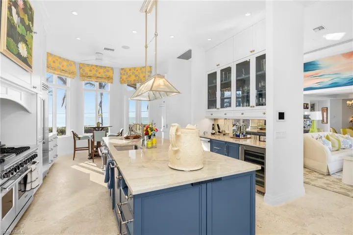 Chef's kitchen featuring Viking double oven gas range,, bar area with beverage drawers, wine cooler, custom cabinetry, breakfast nook