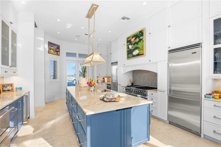 Kitchen - loads of elegant storage and french doors out to back patio and outdoor kitchen