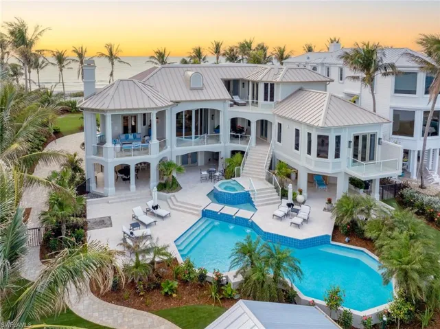 Back of the house with a pool-spa, patios, and balconies