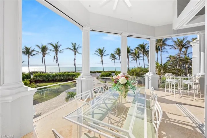 Outdoor dining on your beachfront patio with remote controlled screens