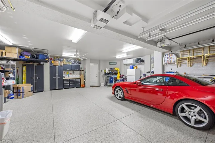 Spacious garage includes built in cabinets, epoxy floor, bike and kayak storage