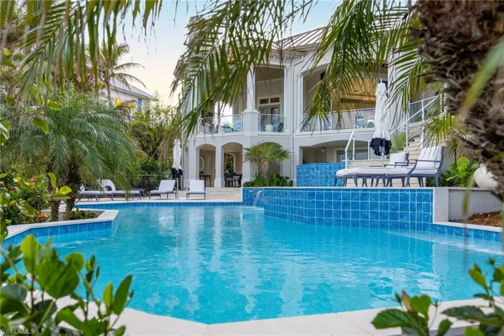 View of pool with pool water feature and a patio area