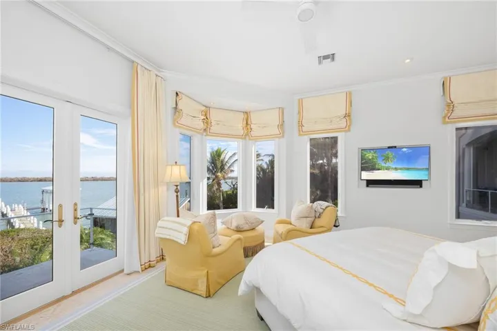 Primary bedroom has french doors out to balcony area; serene sitting area with natural light