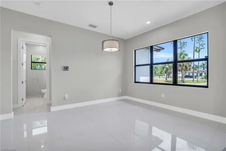Tiled empty room featuring plenty of natural light