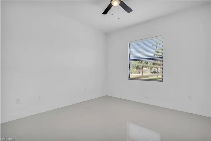 Tiled spare room with ceiling fan