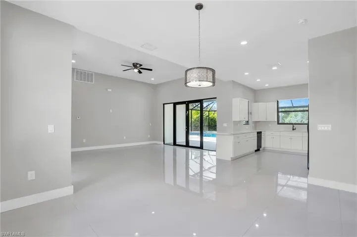 Spare room featuring ceiling fan and light tile floors
