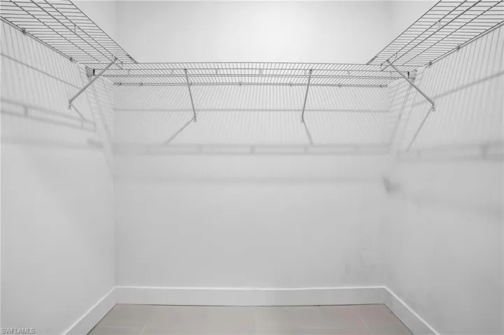Walk in closet featuring tile flooring
