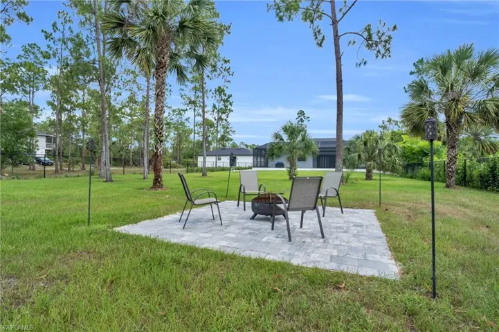 View of yard featuring a patio and a fire pit