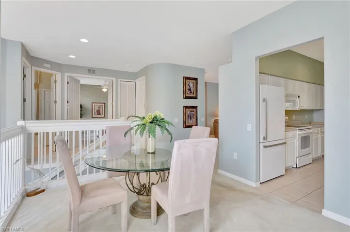Dining area  nicely furnished, featuring light colored carpet, and recessed lighting