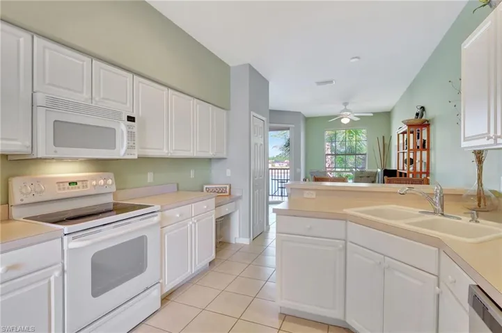 Dining room featuring a ceiling fan, light tile patterned floors, and baseboards
