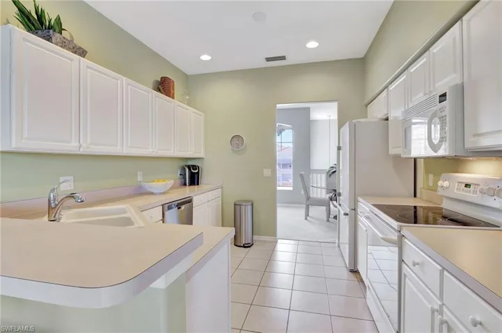 Kitchen that flows to both the dinette and the dining room, lots of cabinet space and pantry