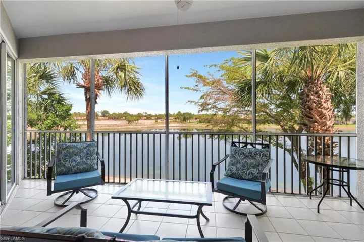 Furnished Screened lanai with access to the primary bedroom and the dinnett area bedroom, lake view,  fan and tile flooring