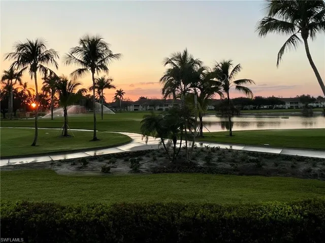 View of property's community with a water view and a yard
