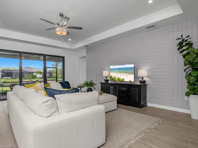 Great room with additional recessed lighting, feature wall, impact glass sliders providing lots of natural light.