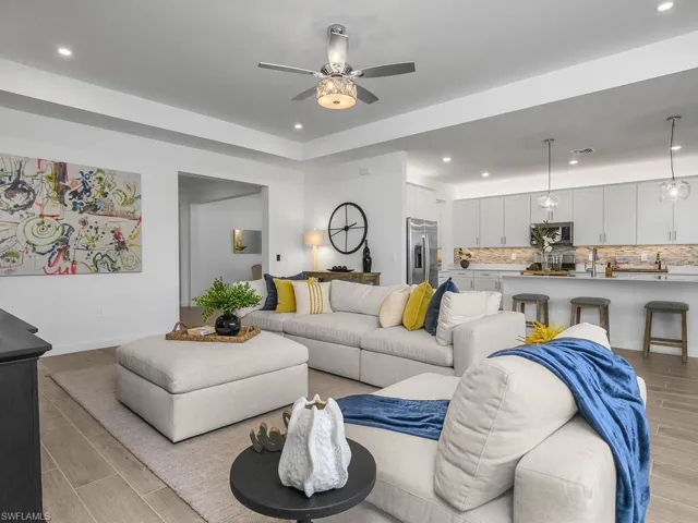 Great room with additional recessed lighting, feature wall, impact glass sliders providing lots of natural light.