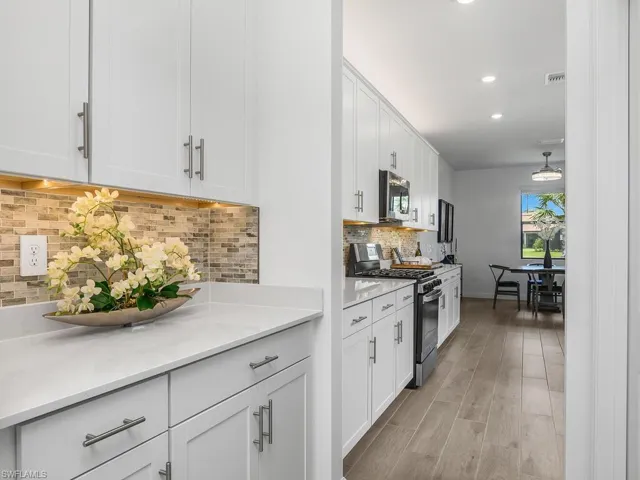 You'll love the coffee bar/butler pantry walk through area adjacent to the walk-in pantry with custom shelving.