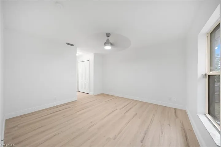 Empty room featuring light wood-style floors and a ceiling fan