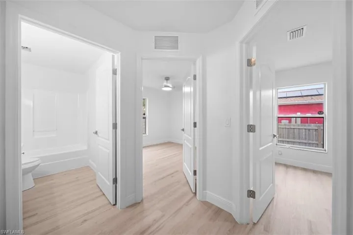 Corridor featuring light wood-type flooring