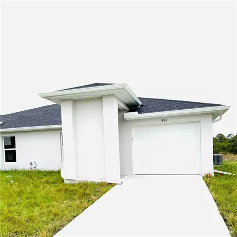 View of side of property with a garage