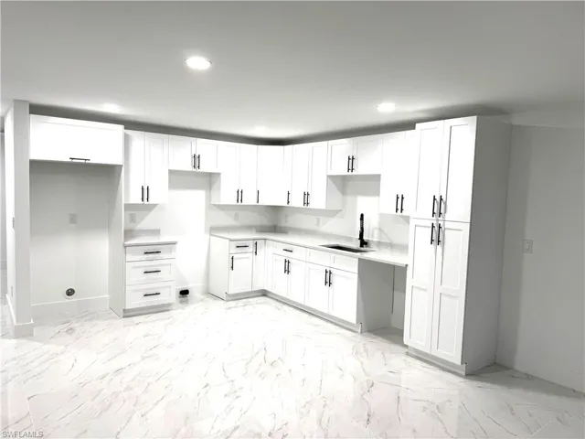 Kitchen with sink and white cabinets