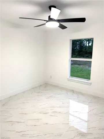 Empty room featuring ceiling fan