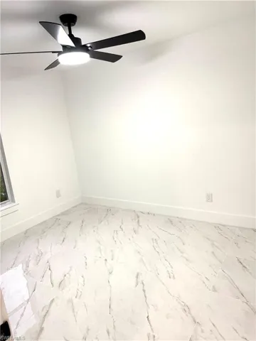 Unfurnished room featuring ceiling fan