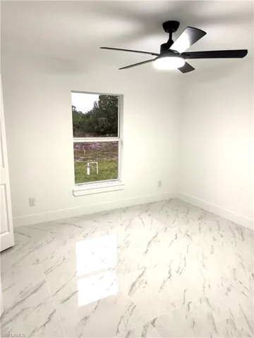 Empty room featuring ceiling fan