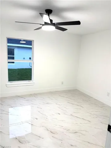 Unfurnished room featuring ceiling fan