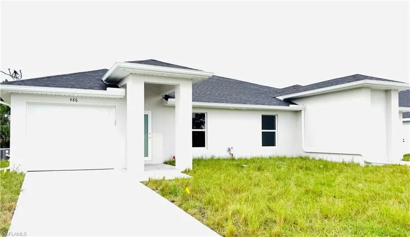 Back of house with a garage