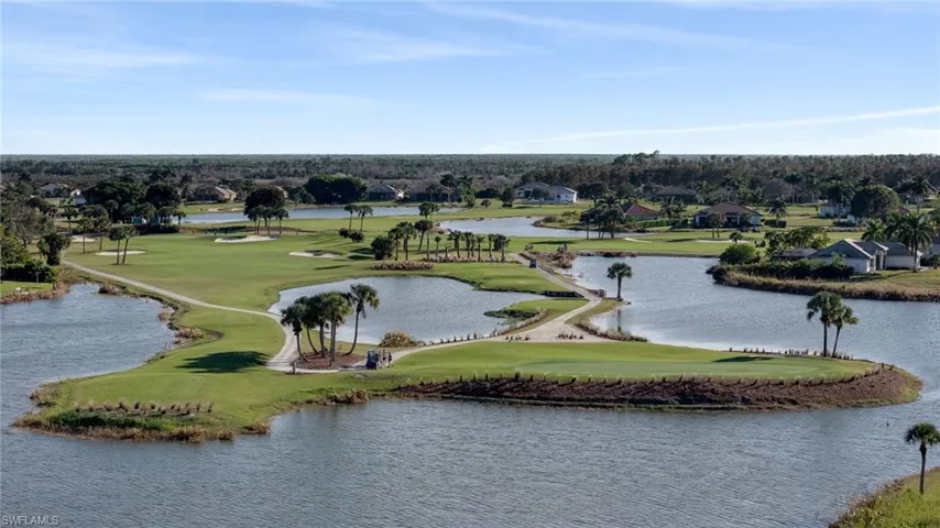 Drone / aerial view of a large body of water and a golf course