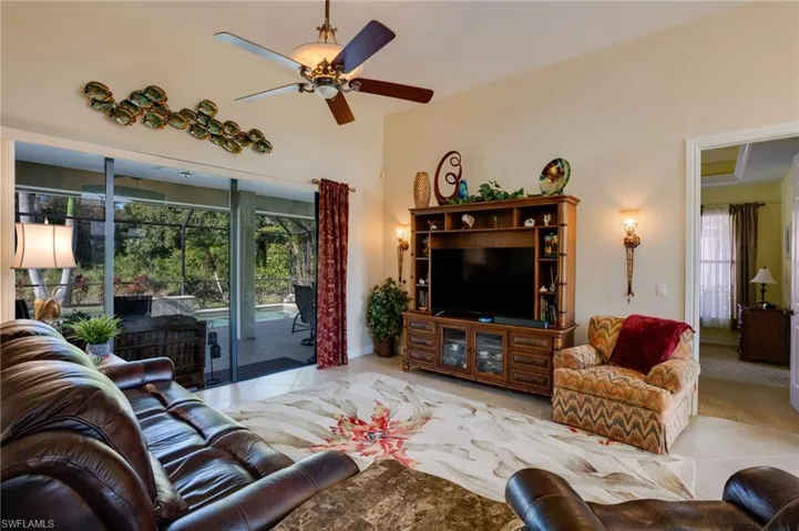 Living area featuring ceiling fan and light tile patterned floors