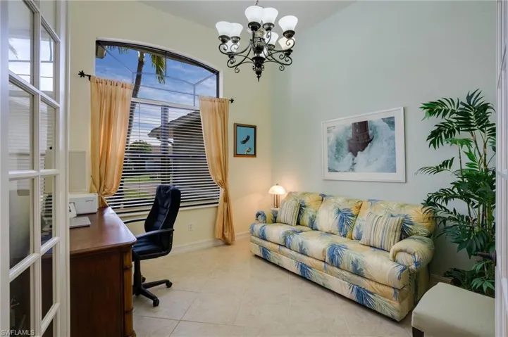 Tiled office featuring a chandelier and baseboards
